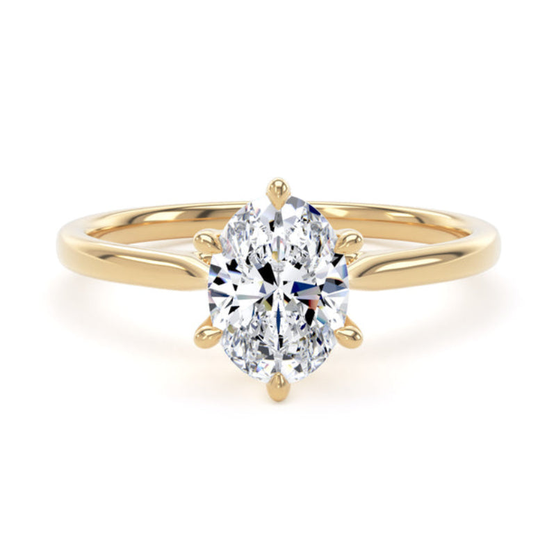 Gold ring with a large diamond on a white background