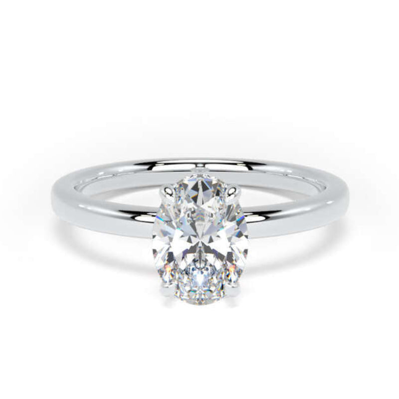 An oval-cut diamond engagement ring with a polished silver-colored band, centered on a clean white background.