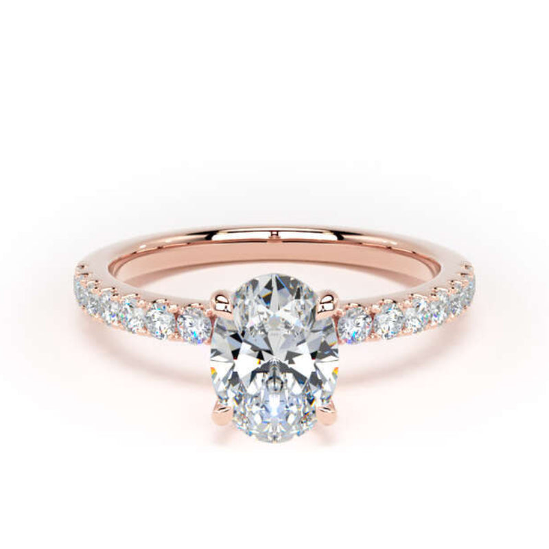 A rose gold engagement ring featuring a round-cut center diamond and a pavé band with small round diamonds, set against a clean white background.
