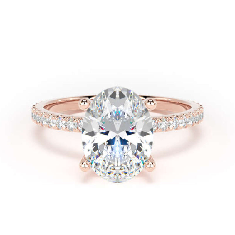 A rose gold engagement ring featuring a large oval-cut center diamond set in a four-prong setting, with a pavé band of smaller diamonds, shown on a clean white background.