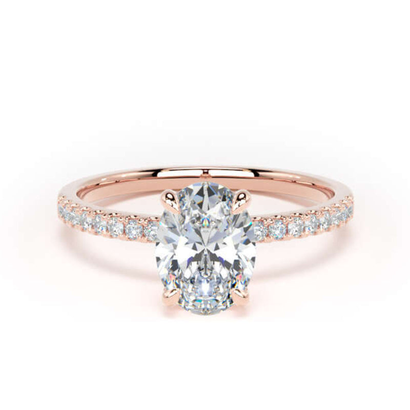 A rose gold engagement ring featuring a round brilliant-cut center stone and a pavé-set band with small clear accent stones, shown on a clean white background.