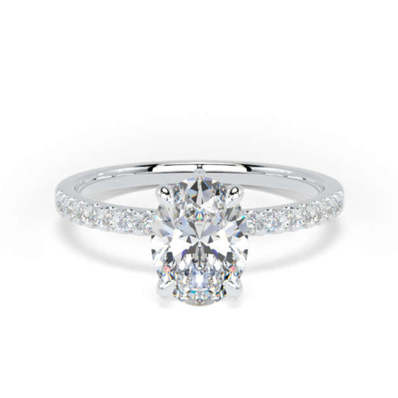 A silver engagement ring featuring a round-cut center diamond and a pavé band with small round diamonds, set against a plain white background.