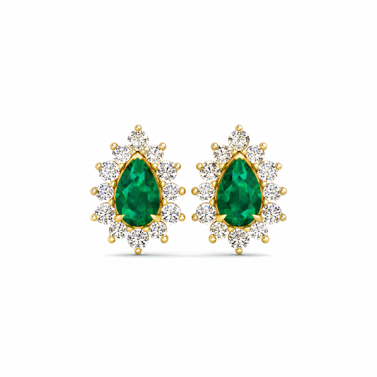 A pair of gold teardrop stud earrings featuring a central green emerald-cut stone surrounded by small clear stones in a sunburst setting, shown on a plain white background.