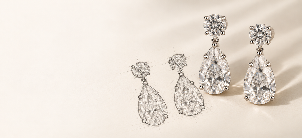 Three pairs of diamond drop earrings in silver-toned settings, arranged on a warm cream background. The earrings feature round and pear-cut clear gemstones with floral crown details.