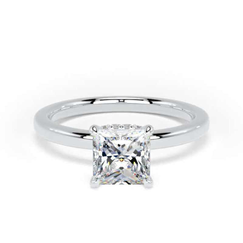 A classic solitaire engagement ring featuring a brilliant round-cut diamond set in a polished white gold or platinum band, shown against a plain white background.