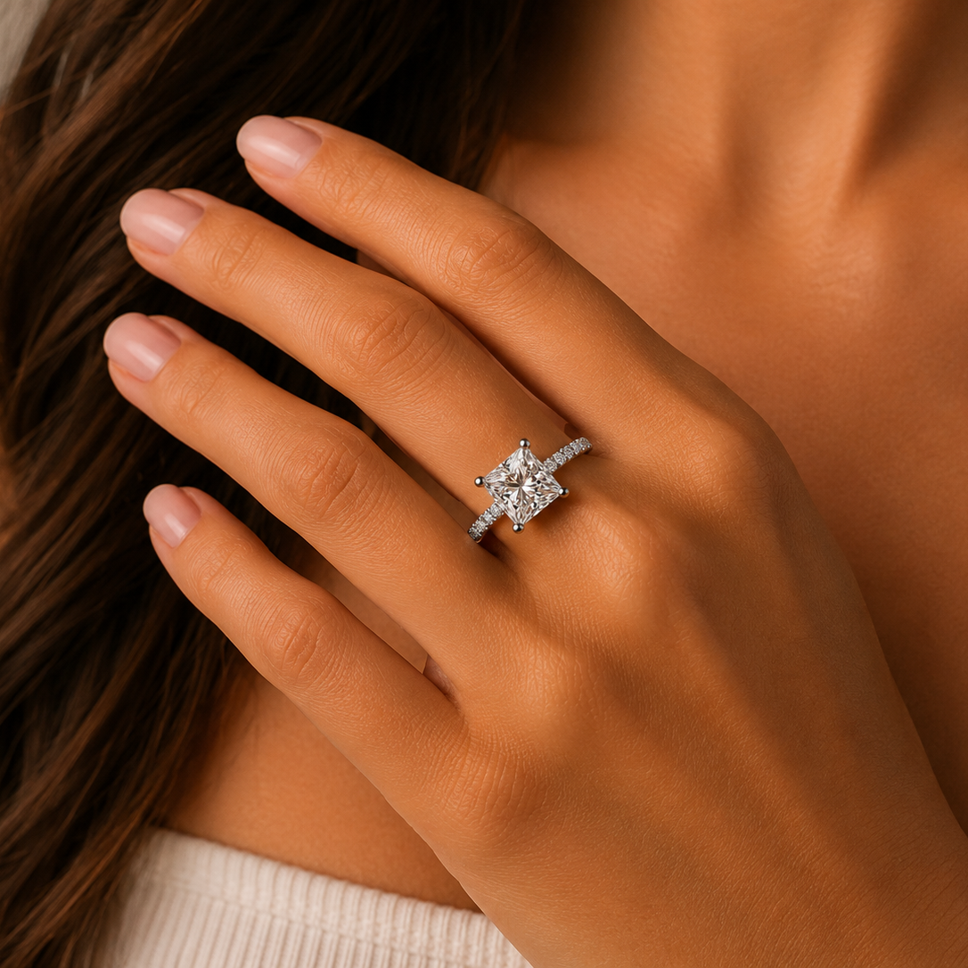 Close-up of a hand wearing a diamond ring with a blurred background