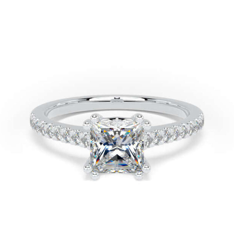A silver engagement ring featuring a princess-cut center diamond surrounded by a halo, with a pavé band set with small round diamonds, shown on a white background.