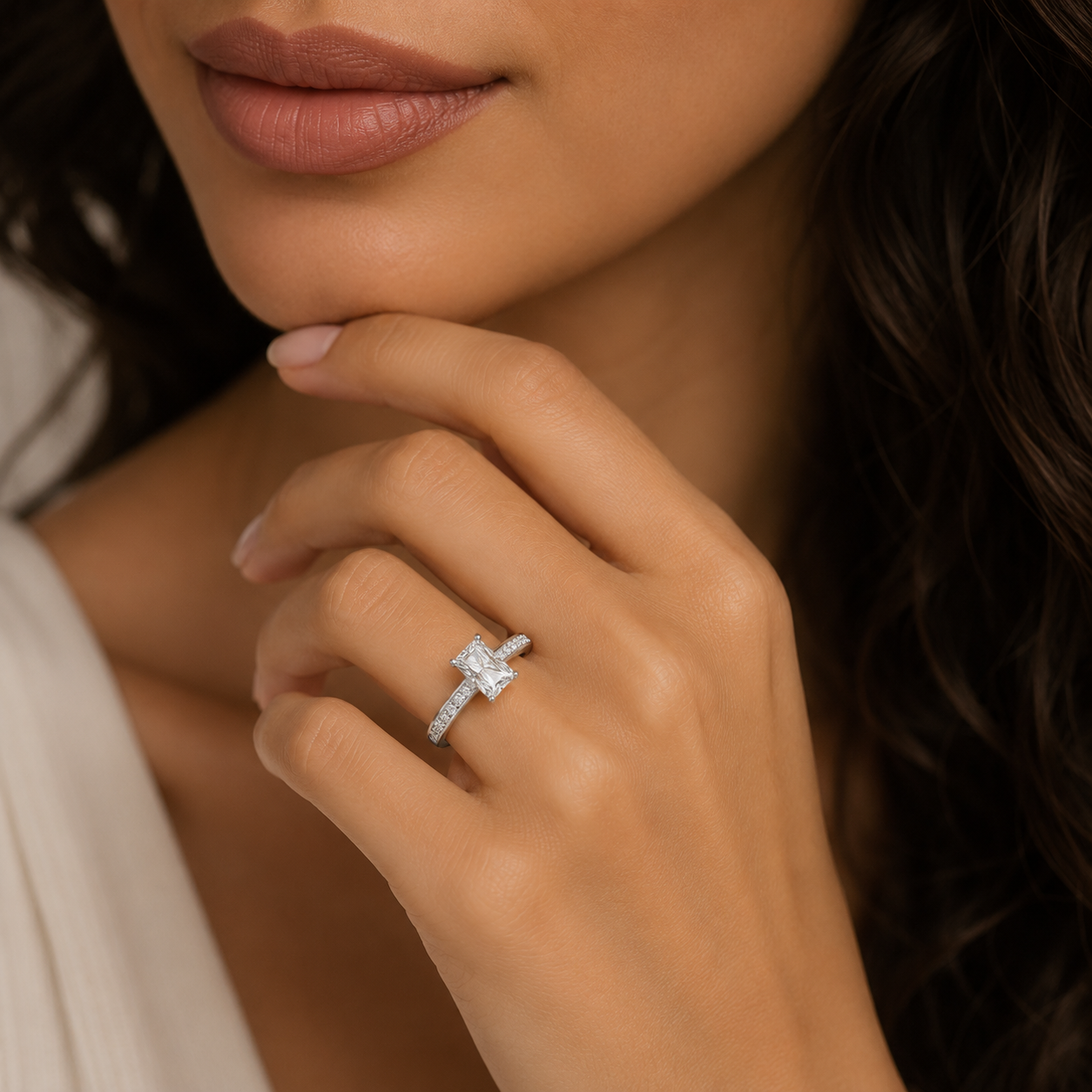 Close-up of a hand wearing a diamond ring with a blurred background