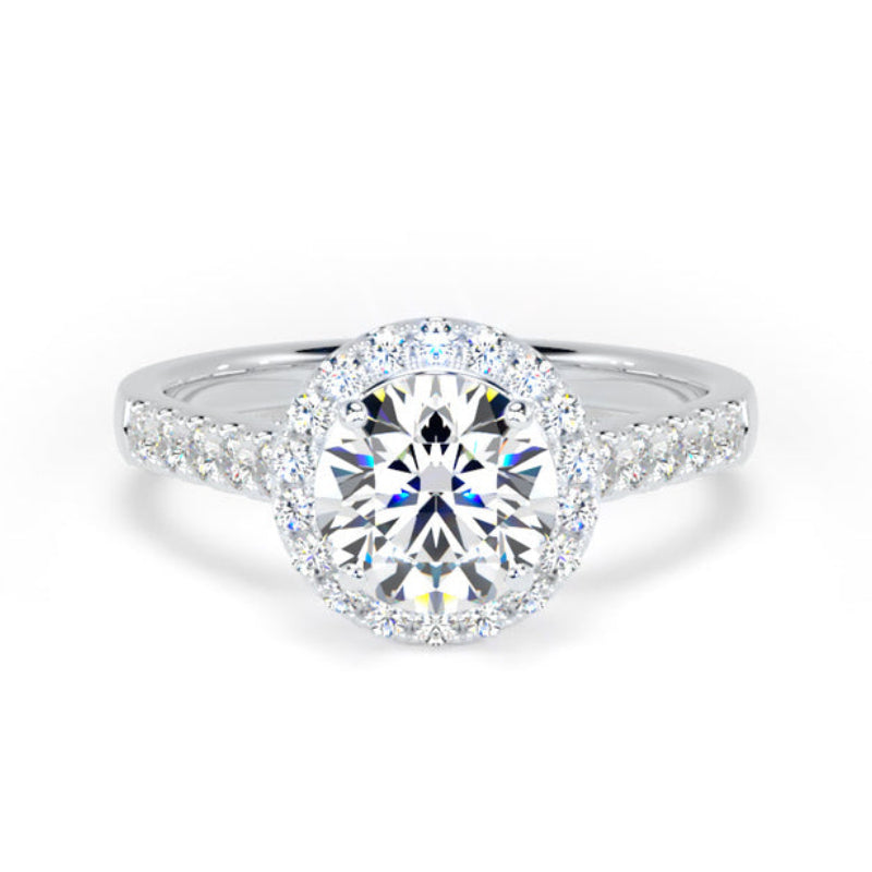 A silver-tone halo engagement ring featuring a round brilliant-cut center diamond surrounded by a double halo of smaller round diamonds, with additional diamonds set along the shoulders of the band, shown on a solid white background.