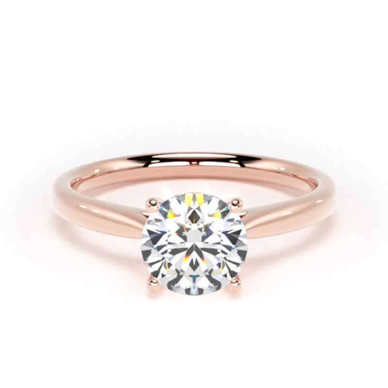 A rose gold solitaire engagement ring with a round brilliant-cut diamond set in a four-prong setting, shown on a clean white background.