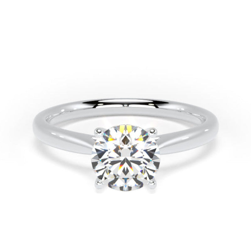 A classic solitaire engagement ring featuring a round brilliant-cut diamond set in a polished white gold or platinum band, shown on a clean white background.