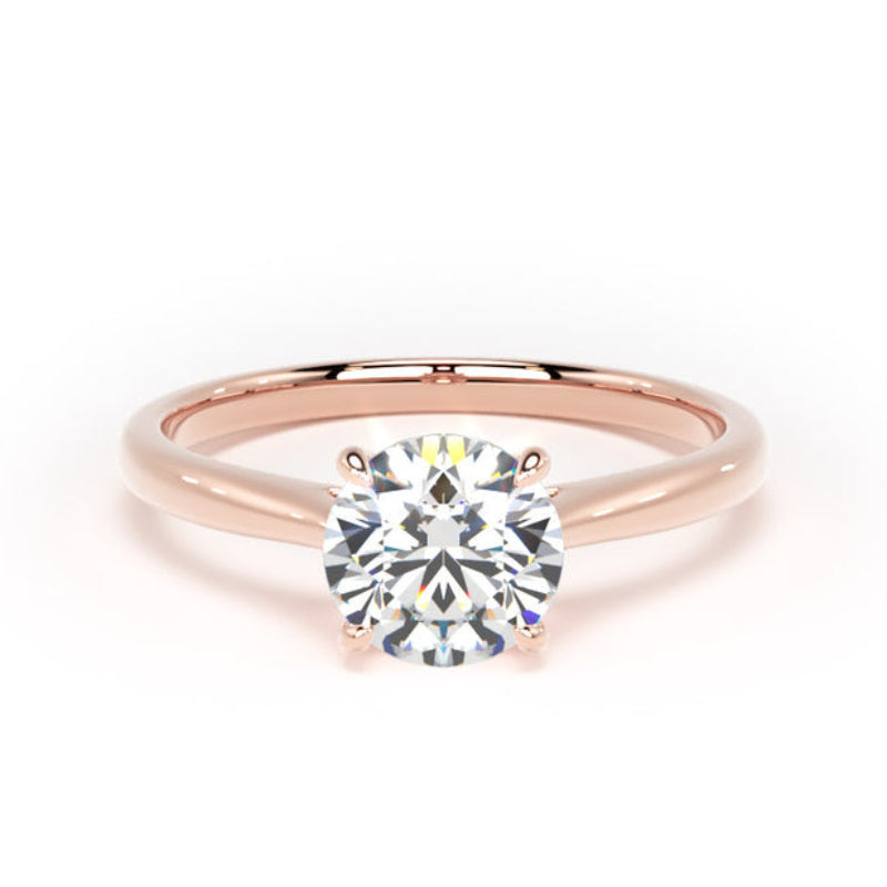 A classic solitaire engagement ring featuring a round brilliant-cut diamond set in a polished rose gold four-prong setting, shown on a clean white background.