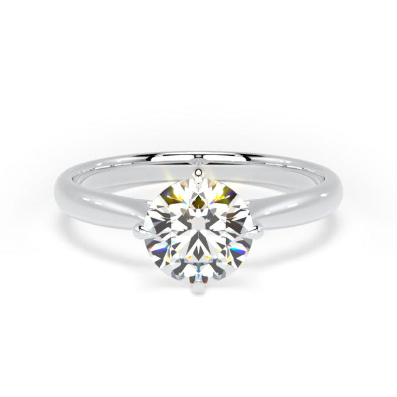 A classic solitaire engagement ring featuring a round brilliant-cut diamond set in a polished white gold or platinum band, centered on a clean white background.