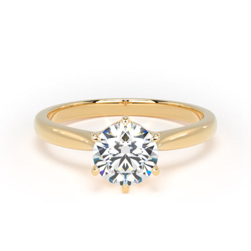 A yellow gold solitaire engagement ring featuring a round brilliant-cut diamond center stone in a four-prong setting, shown on a clean white background.