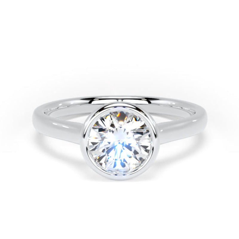 A classic solitaire engagement ring featuring a round brilliant-cut diamond set in a polished white gold or platinum band, shown against a clean white background.