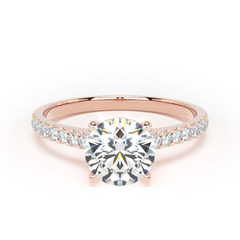 A rose gold engagement ring featuring a round-cut diamond center stone and a pavé band set with small round diamonds, shown on a clean white background.