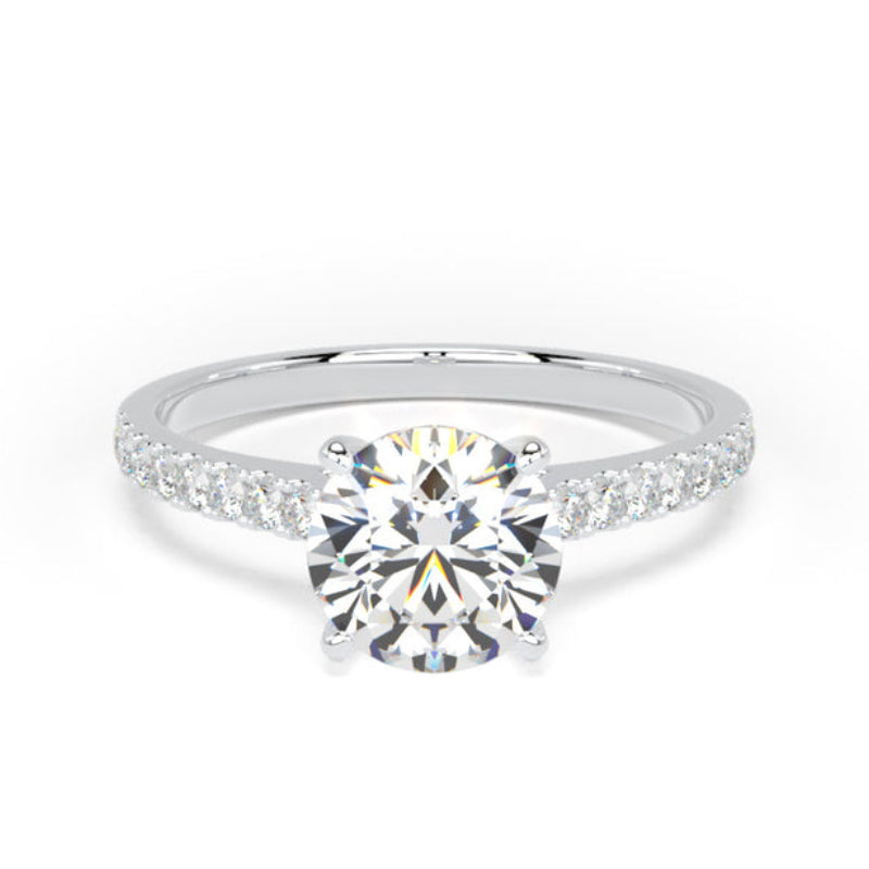 A round-cut diamond engagement ring with a silver-colored band accented by small pavé diamonds, shown on a plain white background.