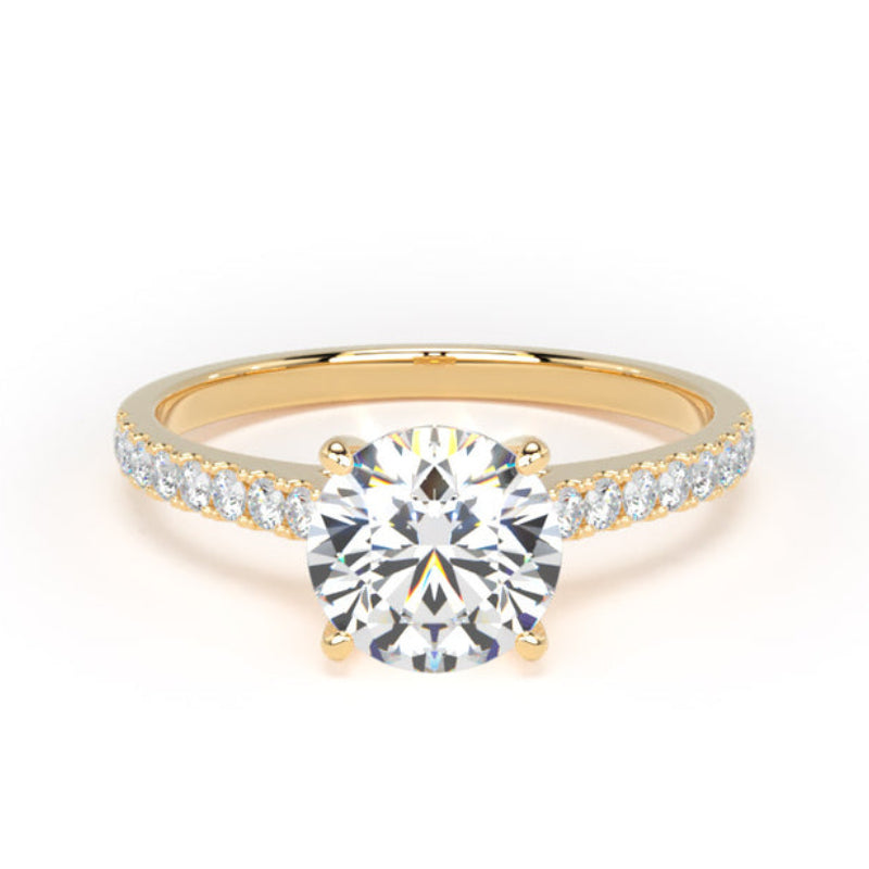 A yellow gold solitaire engagement ring with a round brilliant-cut center diamond and a pavé band set with small round diamonds, shown on a plain white background.