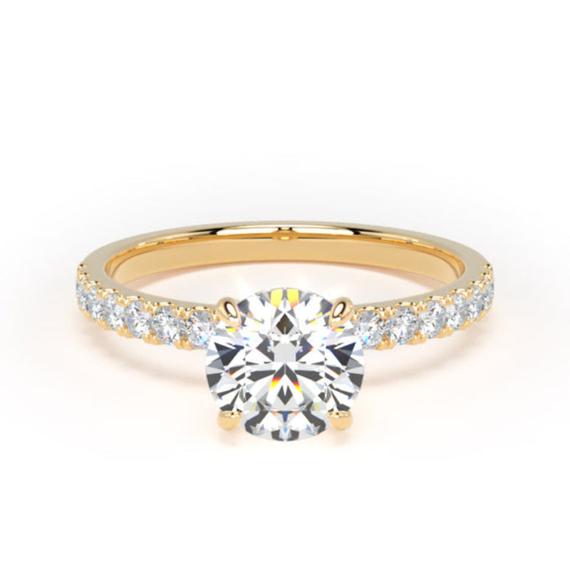 A yellow gold solitaire engagement ring with a round-cut center stone and a pavé band set with small round stones, shown on a plain white background.