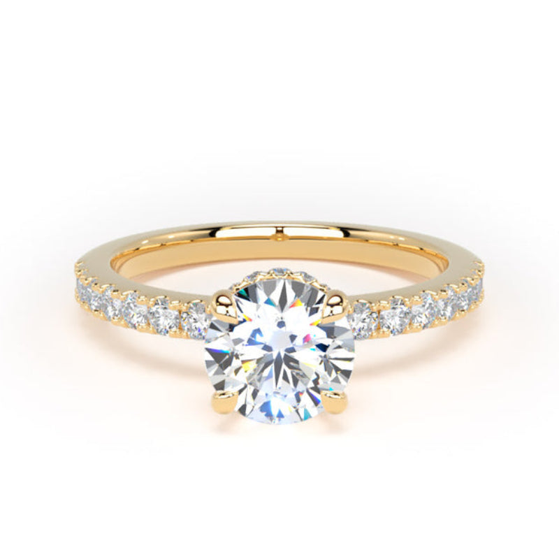 A yellow gold solitaire engagement ring featuring a round brilliant-cut center stone and a pavé band with small round stones, shown on a plain white background.